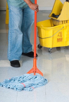 Final Touch Cleaning Service LLC janitor in Ferndale, MI mopping floor.